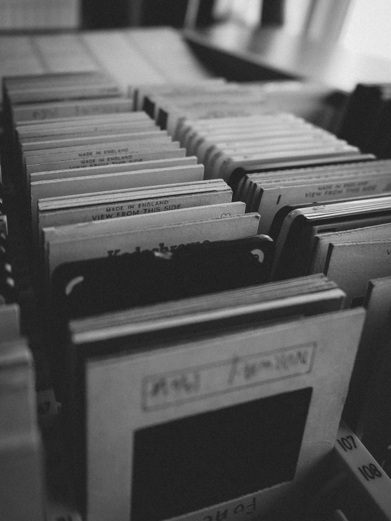 Black and white archival photograph of a synthesizer keyboard on a studio desk