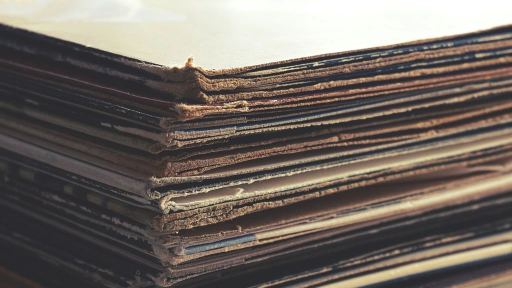 Archival vinyl and master tapes on a researcher's desk